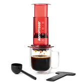 AeroPress Clear Red front view showing transparent chamber and red accents, highlights portability
