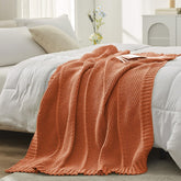 Amélie Home chenille throw front view showing warm orange color and cozy appeal