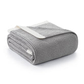 Amélie Home folded throw front view shows cozy grey warmth