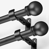AMZSEVEN front view of two black curtain rods packaged, shows value and readiness