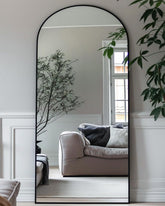 Antok front view of arched full-length mirror shows sleek black frame benefit: modern focal point
