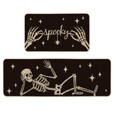 Artoid Mode front view of two black Halloween kitchen mats showing full skeleton spider design and durable surface benefit
