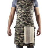 Asaya apron front view in camo showing full coverage and pockets for organized cooking