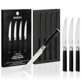 Babish front view of four-steak knife set showing sleek black handles and polished blades, elegant table presentation