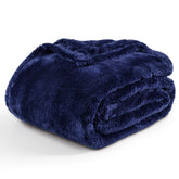Berkshire Blanket front folded in Atlantis dark blue showing plush look and cozy appeal