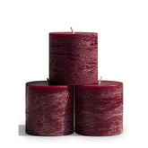 CANDWAX front view of three burgundy pillar candles showing shape and color benefit: cohesive centerpiece