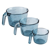 COOK WITH COLOR front view of three blue glass measuring cups, tidy organization benefit