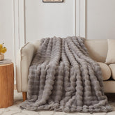 COOVA blanket front view showing grey bubble pattern and elegant finish