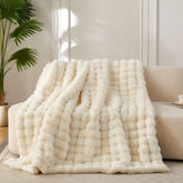 COOVA throw front view on couch showing smooth ivory finish and cozy look
