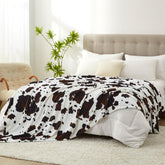 Cozy Bliss front view showing cow print and large queen coverage for stylish warmth
