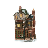 Department 56 Cratchits Corner front view showing lit windows and inviting glow