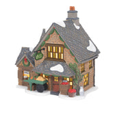 Department 56 front view showing greengrocer façade and inviting lit windows