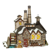 Department 56 front view of distillery lit with warm glow and detailed facade
