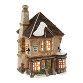 Department 56 front view of tea shoppe showing lit windows and inviting storefront