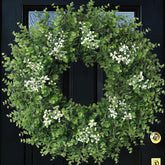 Eqanro front door wreath hung on entrance showing welcoming greenery