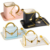 Fovima handbag mug set front view showcasing four colored cups and saucers for stylish serving