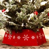 HarcoHome front view of red metal tree collar showing festive snowflakes, attractive base cover