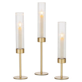 Hewory front view of three gold hurricane holders showing elegant tiered silhouette and balance