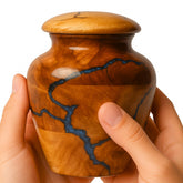 HEYTREND mango wood urn front view showing elegant memorial form and warmth