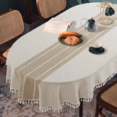 HOMBYS front view of oval tablecloth showing embroidered plaid and full drape benefit