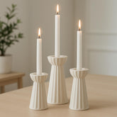 Honeydak front view of three cream ceramic candle holders showing elegant display benefit