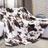 HSEEC folded cow print blanket showing neat packaging and cozy appeal