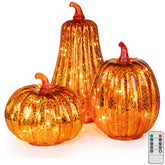 KI Store front view of three lighted glass pumpkins, elegant seasonal glow