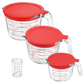 KOMUEE front view of four glass measuring cups showing sizes and lids for organized storage