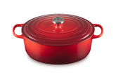 Le Creuset oval Dutch oven front view showing Cerise color and sturdy handles for serving
