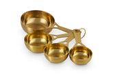 Le Creuset gold measuring cups front view showing polished finish and accuracy