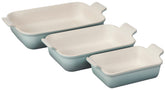 Le Creuset front view of three Sea Salt rectangular dishes showing capacity and design benefit