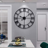 LEIKE front view of black metal Roman wall clock showing bold design and clear time
