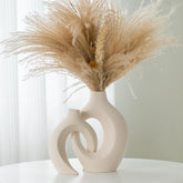 Liotww front view of paired vases showing sculptural embrace and decorative impact