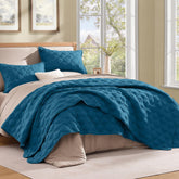 Litanika teal quilt front view showing neat diamond stitch and calming color benefits