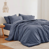 Love's cabin front view of navy seersucker comforter showing elegant styling and cozy look