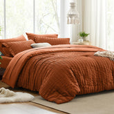Love's cabin front view of terracotta king comforter set showing complete bedding