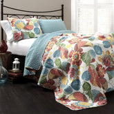Lush Decor Layla quilt front view showing bold orange and blue floral leaf print for vibrant decor