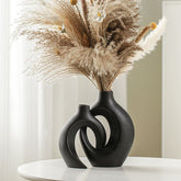 Lvases front view of two off-black snuggle hollow vases showing modern contrast and balance