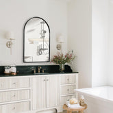 Minuover front view of arched mirror showing elegant silhouette and brightening effect