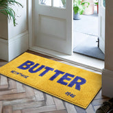 Momlli Butter Rug front view showing bright yellow shape and cozy plush comfort