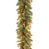 National Tree Company garland front view showing pinecones and berries with warm lights enhancing decor
