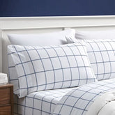 Nautica Twin XL flat sheet spread on bed showing smooth plot blue finish and neat look