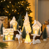 Newtay front view of lighted village creating warm centerpiece glow