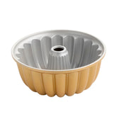 Nordic Ware front view showing gold finish and sculptural swirl pattern, elegant presentation