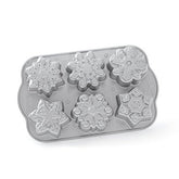 Nordic Ware pan front view showing six snowflake cavities and festive baking design benefit