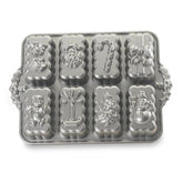 Nordic Ware pan front view showing eight holiday-shaped cavities for festive baking and gifting