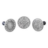 Nordic Ware front view of three stamps showing star designs and benefit of durable cast aluminum