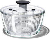 OXO glass salad spinner front view showing clear bowl and pump for elegant serving