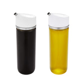 OXO dispenser front view showing glass bottle and stainless spout with tidy look