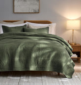 palassio front quilt on queen bed showing olive green stripes and cozy look